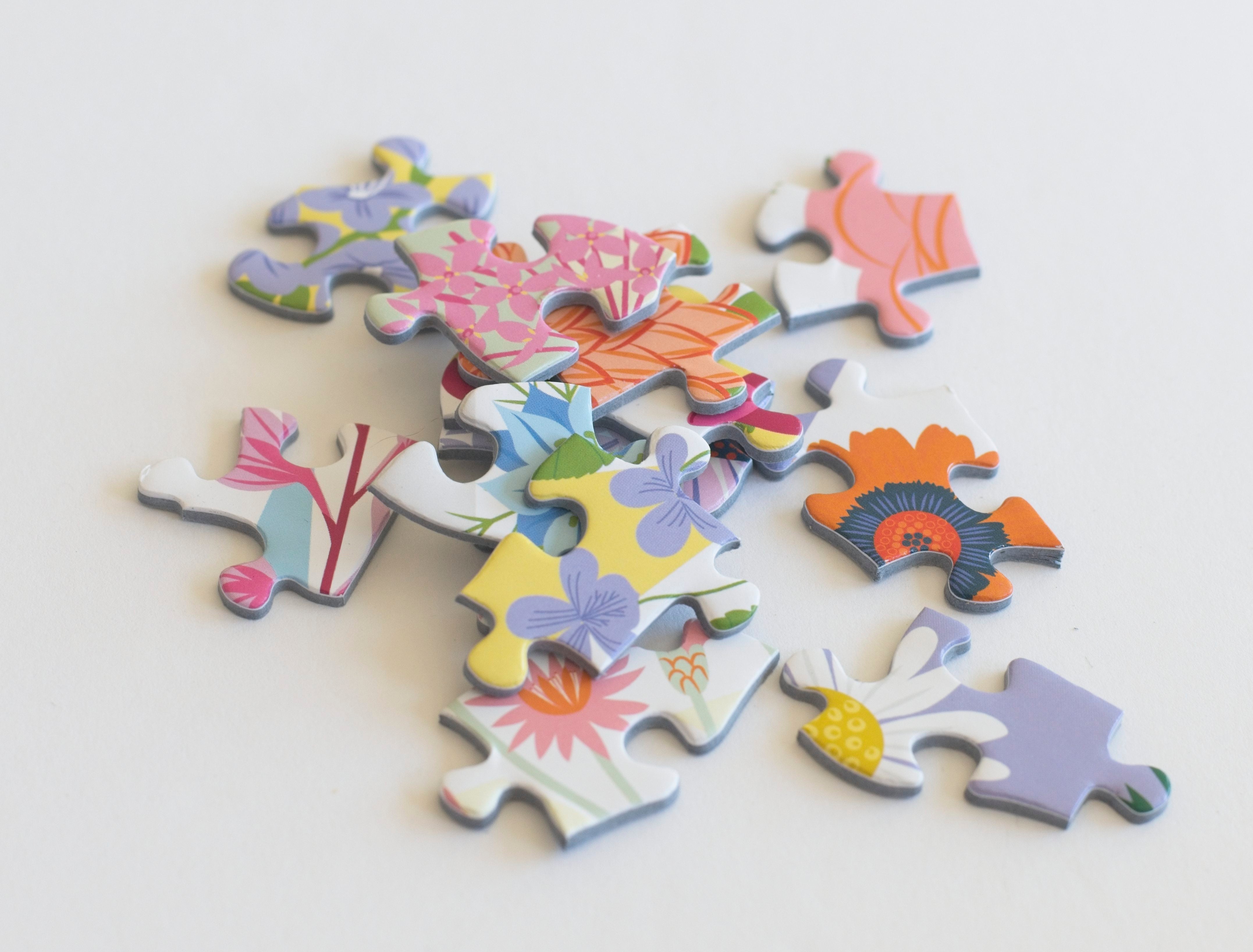Close-up of ABC Flowers jigsaw puzzle pieces from the 500-piece Lellobird puzzle