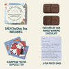 Playin Choc Christmas Collection packaging with chocolate bars, puzzle toy, and fun facts card on a beige background.