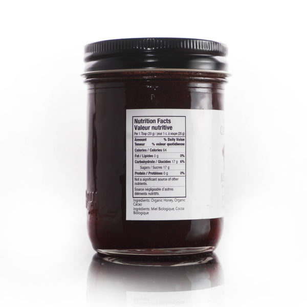 Jar of dark chocolate spread with a nutrition label on a white background
