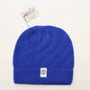 Blue knit beanie with a brand tag on a white background