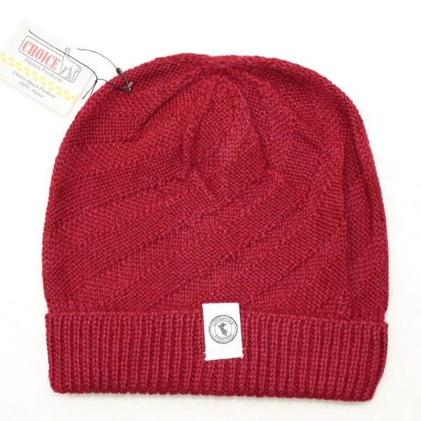Red knit beanie with a brand tag on a white background