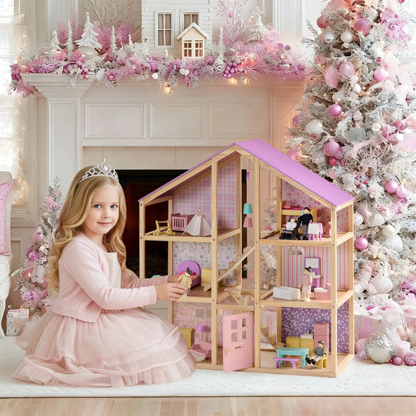 Young girl in a pink dress with a dollhouse and Christmas tree in a decorated room.