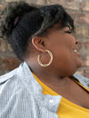 Close-up of Fair Anita Inside Hex Hoops showing inside-hexagon cutout detail in brass finish