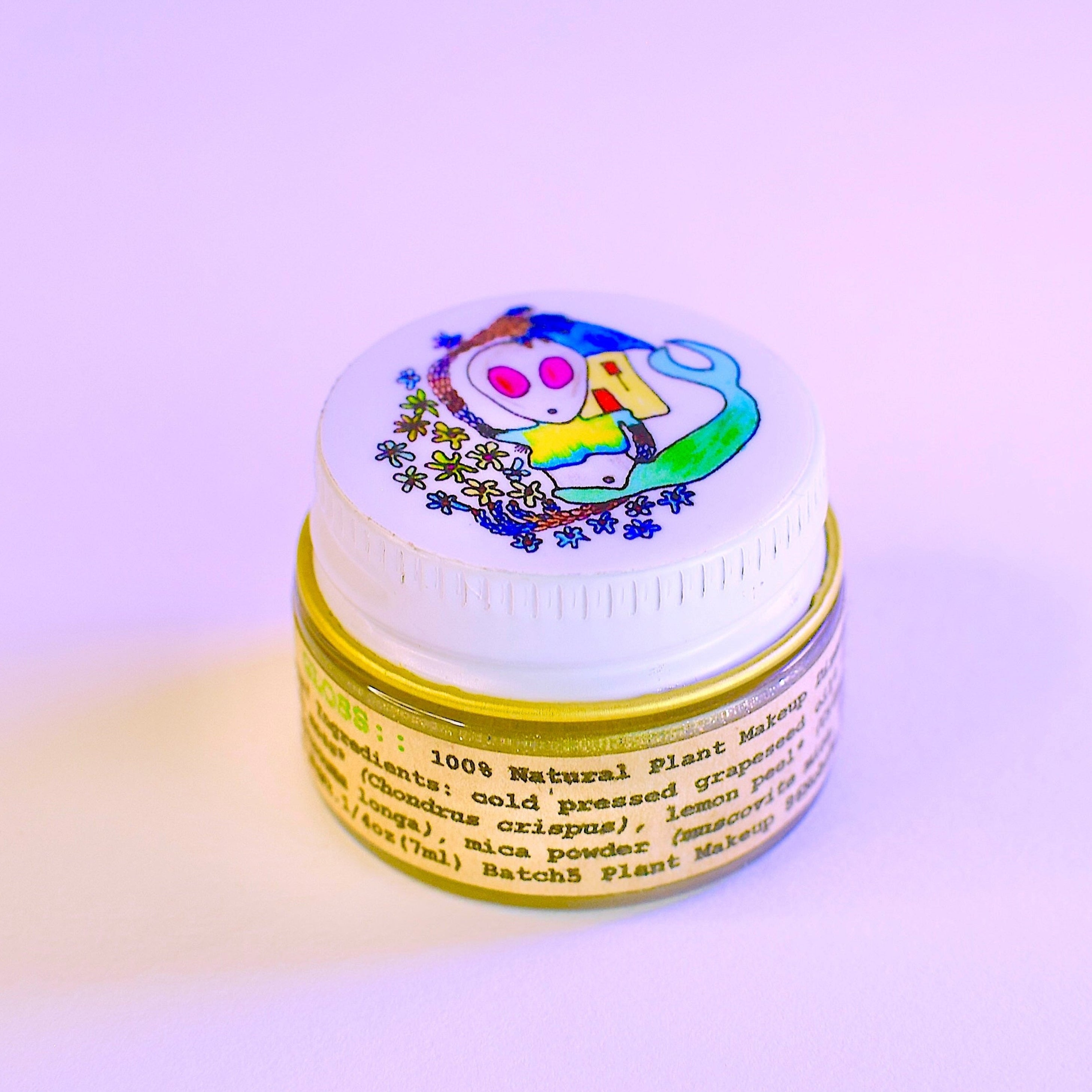 Small container with a colorful label on a light purple background