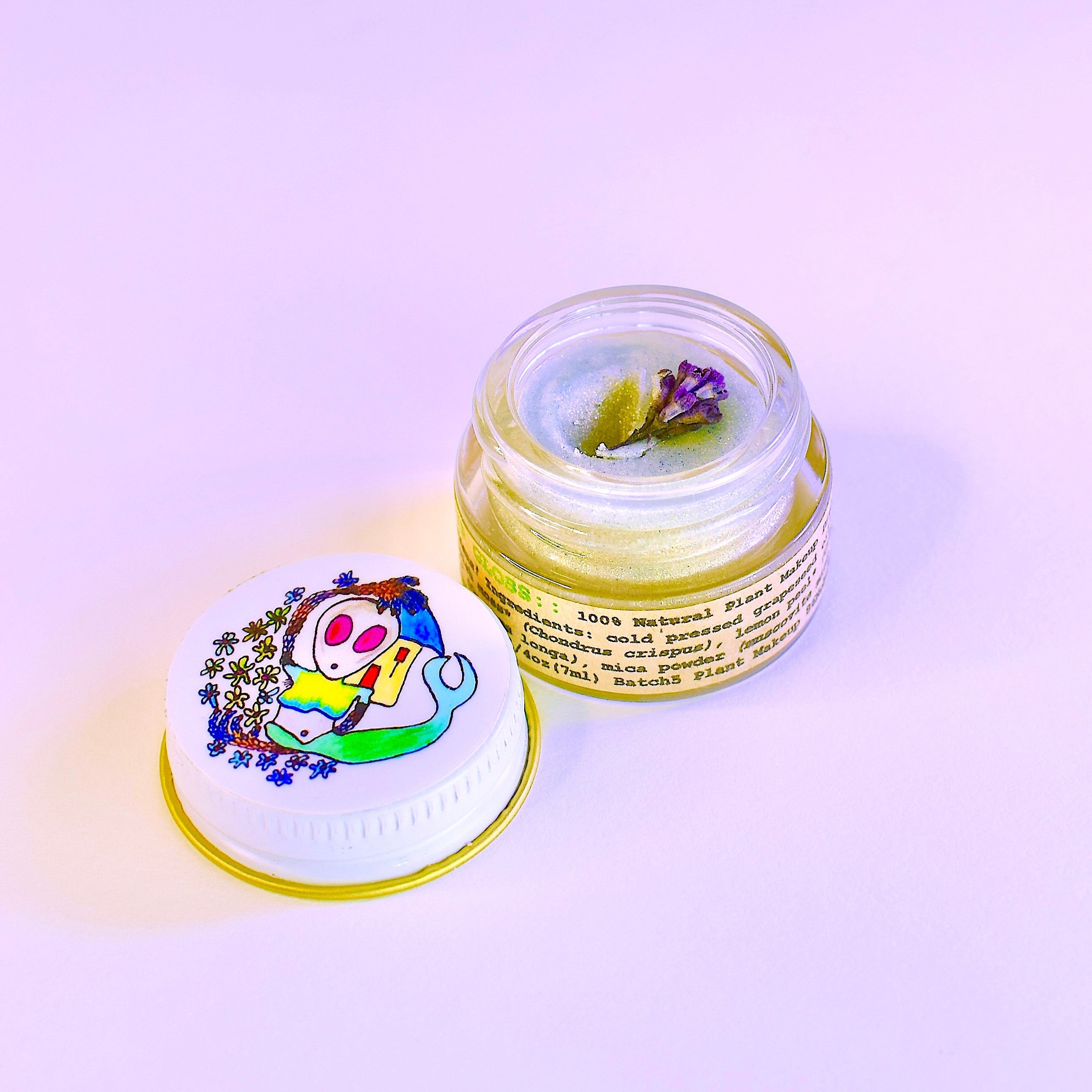 Alien Drip Gloss jar shown with plant-based ingredients
