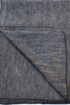 Gray textured fabric with a diagonal fold on a white background