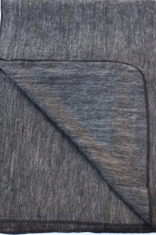 Gray textured fabric with a diagonal fold on a white background