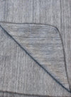 Close-up of gray fabric with a subtle pattern