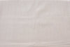 Close-up of a textured beige fabric surface