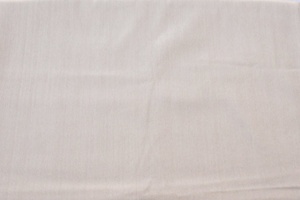 Close-up of a textured beige fabric surface
