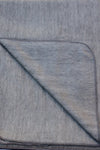 Gray textured fabric with a diagonal fold