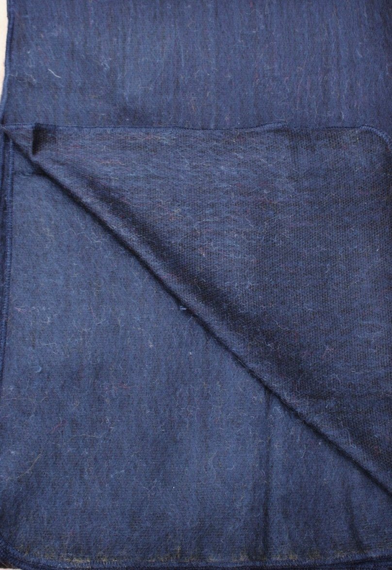 Close-up of blue denim fabric with a diagonal fold