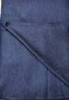 Close-up of blue denim fabric with a diagonal fold
