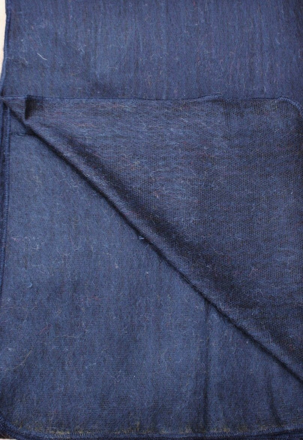 Close-up of blue denim fabric with a diagonal fold