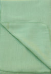 Folded light green fabric with a subtle pattern