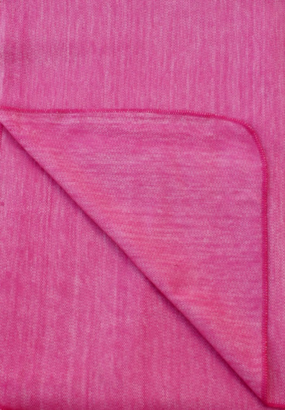 Close-up of pink fabric with a diagonal fold
