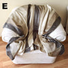 White chair with a striped beige and brown cover on a wooden floor.