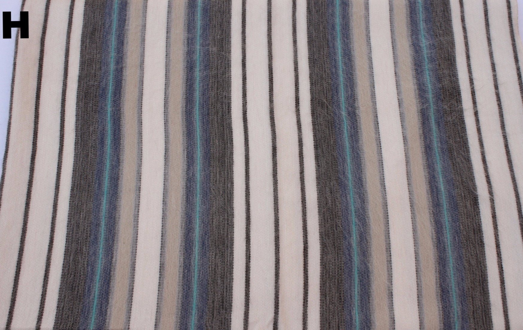 Striped fabric with blue, black, and beige colors.