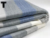 Folded blanket with blue and gray checkered pattern on a white background