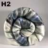 Rolled-up fabric with blue and gray stripes on a light gray background