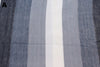 Multiple striped alpaca bed blanket colour options laid out, handcrafted in Otavalo Ecuador