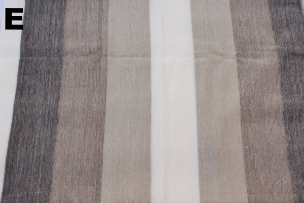 Striped fabric with brown, beige, and white colors on a plain background