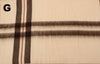 Close-up of a fabric with plaid pattern on a beige background