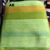 Green and yellow striped fabric with 'AE' initials on a plain background