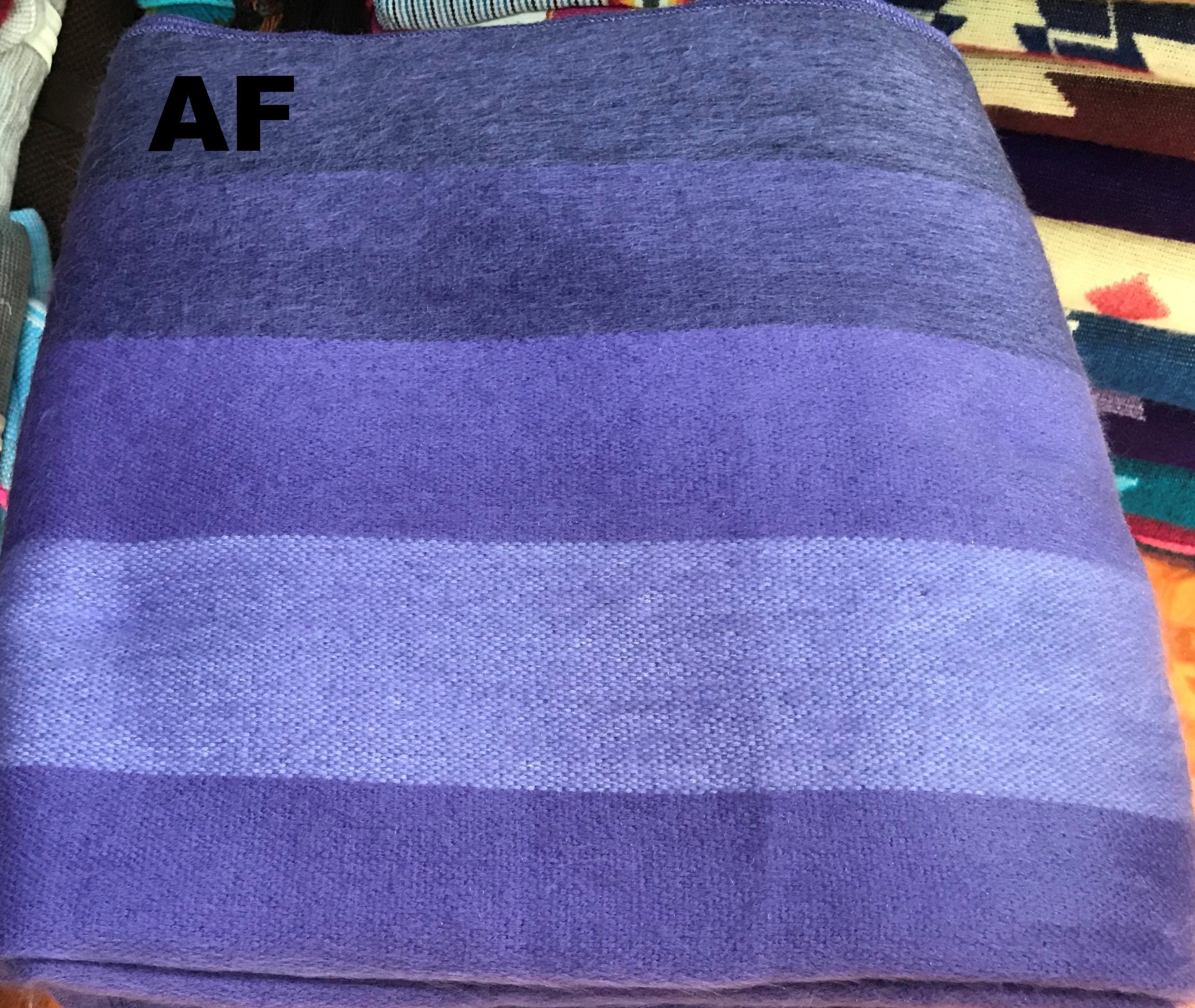 Blue striped towel with 'AF' label on a colorful background
