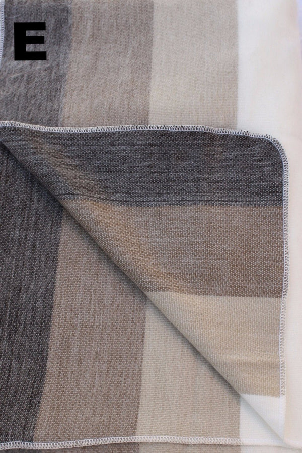 Textured fabric with a geometric pattern in shades of brown and gray on a white background.