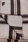Folded plaid blanket with brown and beige stripes on a white background