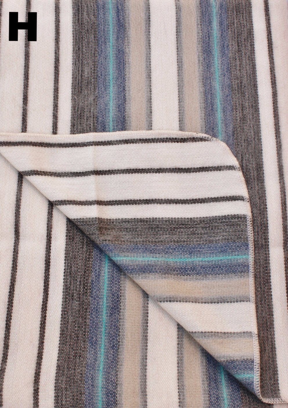 Close-up of striped fabric with a pattern of black, blue, and beige lines.