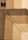 Close-up of a folded fabric with brown and beige pattern, labeled 'M'.