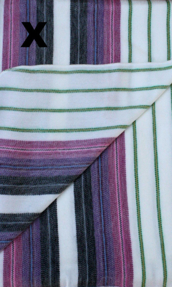 Close-up of striped fabric with purple, green, and white colors.