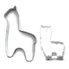 Metallic tooth and cat-shaped cookie cutters on a white background