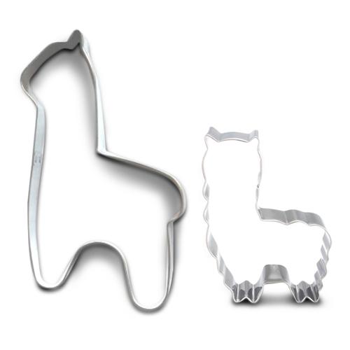 Metallic tooth and cat-shaped cookie cutters on a white background