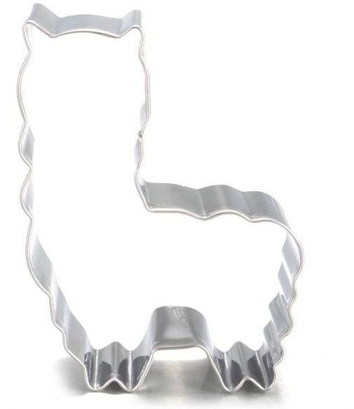 Metallic cookie cutter shaped like a cat on a white background