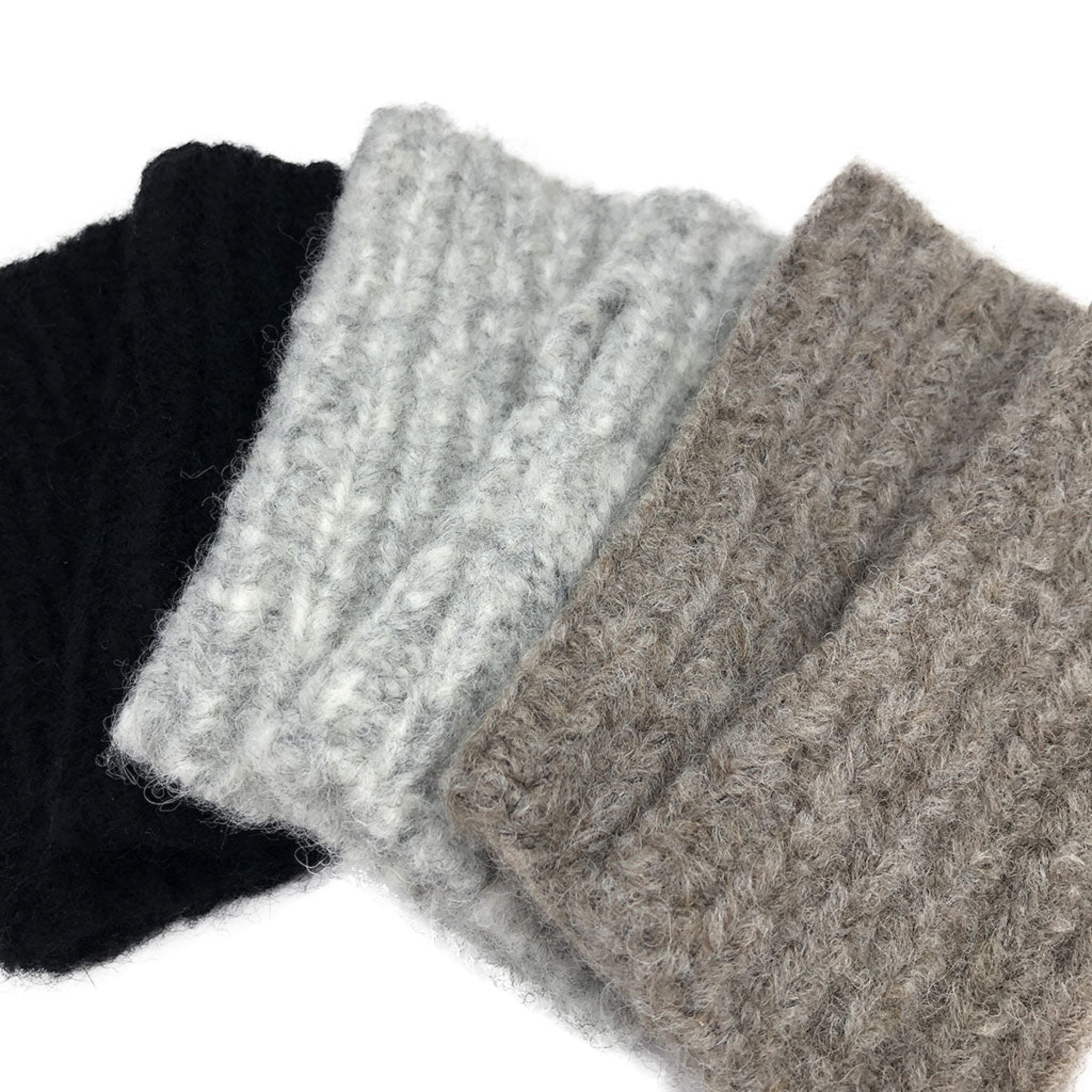 Three knitted headbands in black, gray, and beige on a white background