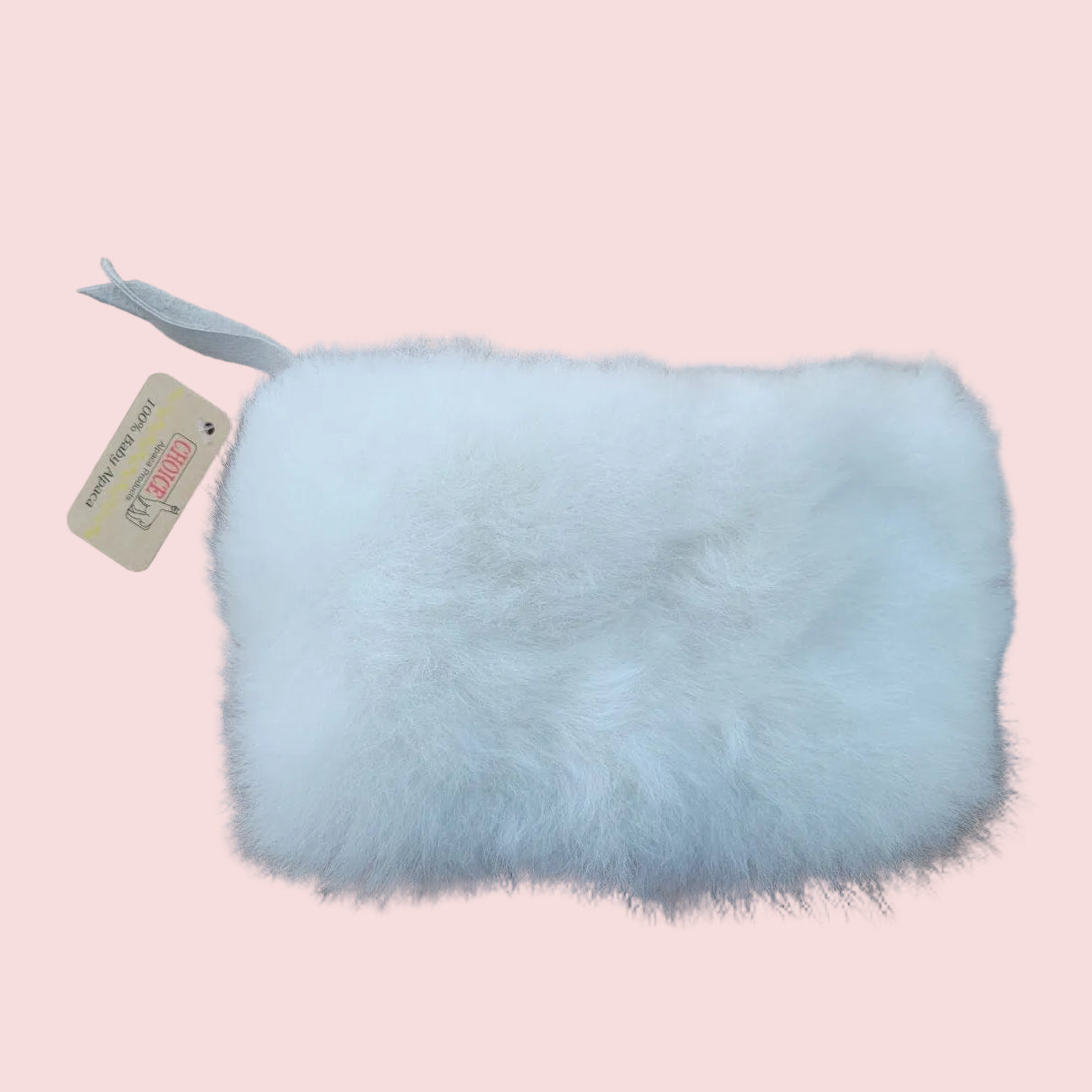 White fur pouch with a tag on a brown background