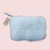 White fur pouch with a tag on a brown background