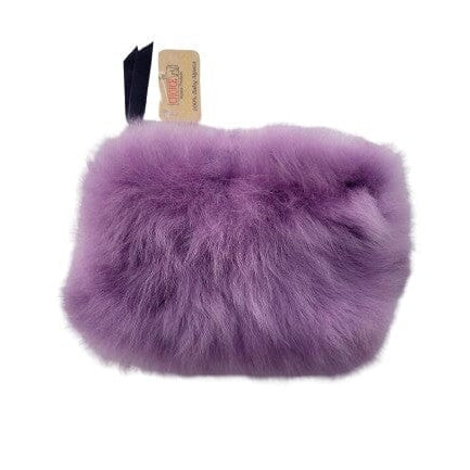 Purple fluffy dog toy with a tag on a white background