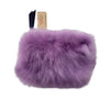 Purple fluffy dog toy with a tag on a white background