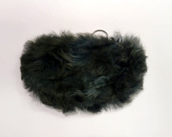 Dark green fur pouch on a white background