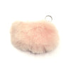 Pink fluffy keychain on a white background