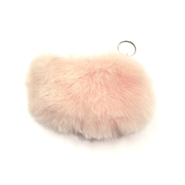Pink fluffy keychain on a white background