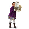 Close-up of the plush alpaca stage puppet showing detail of its soft fleece-like fabric and movable mouth