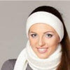 Woman wearing a white headband and scarf with a neutral background