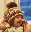 Alpaca blend chullo earflap hat for infants and toddlers, made in Peru, shown in assorted colors