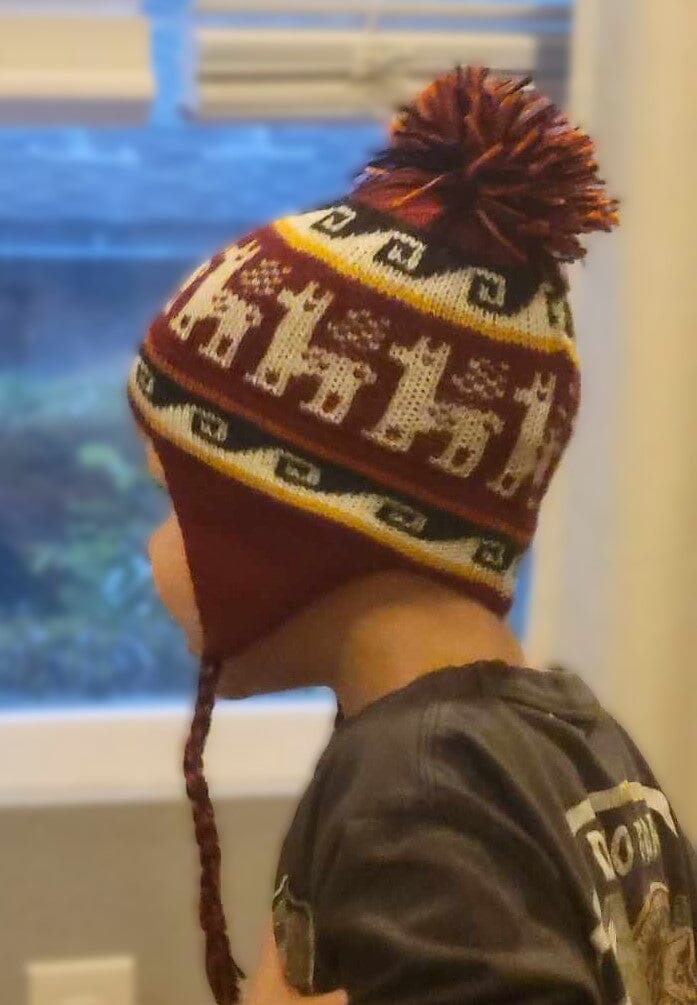 Close-up of soft alpaca chullo hat for babies and toddlers with traditional Peruvian earflap design