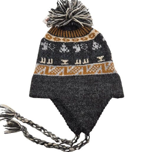 Knitted hat with a patterned band and pom-pom on a white background